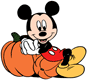Mickey Mouse leaning against pumpkins